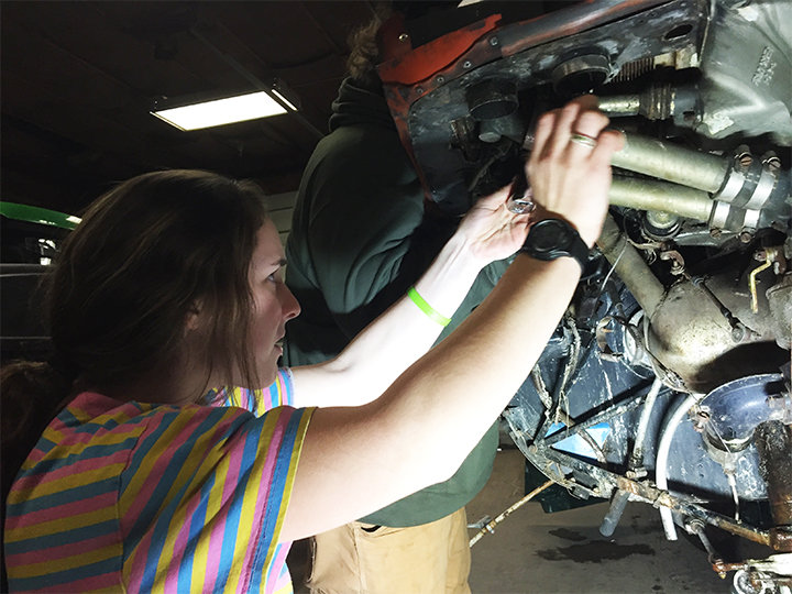 Junior Saydie Kosmuch prepares an aircraft engine for removal.